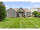 Spacious backyard with a covered patio, lush green grass, and mature landscaping at 7016 Bareland Rd, Fort Mill, SC 29707