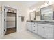 Bright bathroom features double vanity with granite countertop, framed mirrors, and walk-in closet at 7016 Bareland Rd, Fort Mill, SC 29707