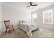 The bedroom with carpet flooring, two large windows, and a ceiling fan at 7016 Bareland Rd, Fort Mill, SC 29707