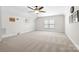 Spacious bedroom with plush carpeting, a ceiling fan, and a window offering natural light at 7016 Bareland Rd, Fort Mill, SC 29707