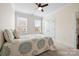 A well-lit bedroom featuring neutral walls, two windows, and carpet flooring at 7016 Bareland Rd, Fort Mill, SC 29707