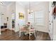 Cozy breakfast nook with natural light, stylish chandelier, and adjacent laundry room at 7016 Bareland Rd, Fort Mill, SC 29707