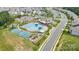 Aerial shot of a neighborhood pool and recreation area featuring tennis courts and playground at 7016 Bareland Rd, Fort Mill, SC 29707