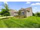 Well-maintained home with stone accents, lush green lawn, and mature landscaping on a sunny day at 7016 Bareland Rd, Fort Mill, SC 29707