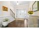 Elegant foyer with hardwood flooring, staircase, and decorative accents for a welcoming entrance at 7016 Bareland Rd, Fort Mill, SC 29707