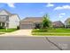 Beautiful home with a well-kept lawn, stone accents, and a two-car garage in a residential neighborhood at 7016 Bareland Rd, Fort Mill, SC 29707