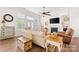 Cozy living room with hardwood floors, a fireplace, and ample natural light from large windows and glass doors at 7016 Bareland Rd, Fort Mill, SC 29707