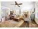 Open-concept living room with hardwood floors, ceiling fan, stylish furniture and seamless flow into the kitchen at 7016 Bareland Rd, Fort Mill, SC 29707