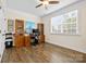 The office with wooden floors, a ceiling fan, and a large window at 7016 Bareland Rd, Fort Mill, SC 29707