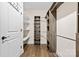 A large walk-in closet with shelving, wooden floors, and an open door at 7016 Bareland Rd, Fort Mill, SC 29707