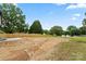 Large backyard with new fence, steps, and newly seeded lawn on a sunny day at 705 Sunderland Sw Rd, Concord, NC 28027