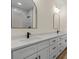 Modern bathroom features dual sinks, white cabinets, matte black hardware, and geometric tiled shower at 705 Sunderland Sw Rd, Concord, NC 28027