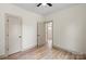 Bedroom features neutral walls, wood-look floors, and an open door at 705 Sunderland Sw Rd, Concord, NC 28027