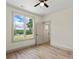 Bedroom with hardwood floors, large windows, and white paint and trim at 705 Sunderland Sw Rd, Concord, NC 28027
