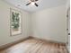 Cozy bedroom features wood-look flooring and a large window with natural light at 705 Sunderland Sw Rd, Concord, NC 28027