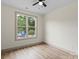 Bright bedroom features a ceiling fan, large window, and wood-look flooring for a modern touch at 705 Sunderland Sw Rd, Concord, NC 28027