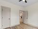 Neutral bedroom boasts wood-look floors, closet and open door for a smooth transition to other rooms at 705 Sunderland Sw Rd, Concord, NC 28027
