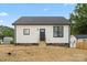 Freshly renovated home featuring white siding, black front door, new windows, and foundation at 705 Sunderland Sw Rd, Concord, NC 28027