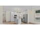 Bright kitchen features stainless steel appliances, white cabinets, an island and hardwood floors at 705 Sunderland Sw Rd, Concord, NC 28027