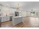 Open concept kitchen with island, stainless steel appliances and hardwood floors at 705 Sunderland Sw Rd, Concord, NC 28027