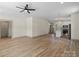 Open living room shows hardwood floors and adjoins the kitchen, windows and doors at 705 Sunderland Sw Rd, Concord, NC 28027