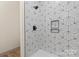 The shower has a modern design with geometric tile and black hardware and in-wall niche at 705 Sunderland Sw Rd, Concord, NC 28027