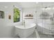 A bright bathroom with a contemporary tub, white subway tile, black-and-white tile flooring, and dual vanities at 7166 Dove Field Ln, Fort Mill, SC 29707