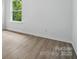 Bright room with wood-look flooring and large windows offering natural light at 7166 Dove Field Ln, Fort Mill, SC 29707