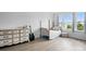 Sunlit bedroom featuring wood-look flooring, neutral decor, and large windows at 7166 Dove Field Ln, Fort Mill, SC 29707