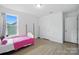 This bedroom features wood floors, bright light, and ample space at 7166 Dove Field Ln, Fort Mill, SC 29707