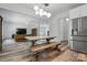 Open concept dining room with views into kitchen, dining table, and stainless refrigerator at 7166 Dove Field Ln, Fort Mill, SC 29707