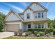 Beautiful two-story home with a tidy front yard and a spacious two-car garage at 7166 Dove Field Ln, Fort Mill, SC 29707