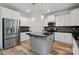 Bright kitchen featuring granite countertops, stainless appliances, and modern white cabinets with an island at 7166 Dove Field Ln, Fort Mill, SC 29707