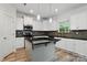 Contemporary kitchen with stainless appliances, white cabinets, an island, and modern backsplash at 7166 Dove Field Ln, Fort Mill, SC 29707