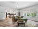 Inviting living room features wood floors, comfortable sofa, and natural light from large windows at 7166 Dove Field Ln, Fort Mill, SC 29707