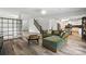 Bright and airy living room with modern flooring and comfortable green sectional sofa with decorative pillows at 7166 Dove Field Ln, Fort Mill, SC 29707