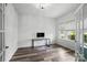 Bright home office featuring luxury vinyl flooring, large windows, and stylish French doors at 7166 Dove Field Ln, Fort Mill, SC 29707