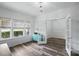 Sunlit home office with luxury vinyl flooring, a colorful cabinet, and large windows with blinds at 7166 Dove Field Ln, Fort Mill, SC 29707