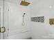 Modern walk-in shower with rain shower head, bench, and decorative patterned tile at 7166 Dove Field Ln, Fort Mill, SC 29707