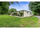 Spacious backyard featuring a well-maintained lawn, mature trees, and a charming walkway leading to the home at 806 N Central Ave, Locust, NC 28097