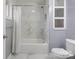 Bright bathroom featuring a white shower and tub, complemented by marble tile and gray walls at 806 N Central Ave, Locust, NC 28097