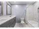 Well-lit bathroom with double vanity sinks, modern mirrors, and a shower-tub combination at 806 N Central Ave, Locust, NC 28097