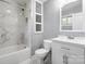 Well-lit bathroom with white vanity, marble countertop, and a framed mirror over the sink at 806 N Central Ave, Locust, NC 28097