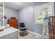Sunlit bedroom with wood floors, a large window, and a desk setup perfect for working from home at 806 N Central Ave, Locust, NC 28097