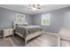 Bright bedroom with wood floors, natural light, and a ceiling fan creates a relaxing atmosphere at 806 N Central Ave, Locust, NC 28097