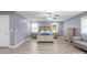 Bright bedroom with wood floors, two windows, a ceiling fan, and neutral-colored furniture at 806 N Central Ave, Locust, NC 28097