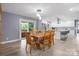 Well-lit dining area with wood floors, adjacent to a modern kitchen and an outdoor patio at 806 N Central Ave, Locust, NC 28097