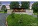 Charming single-story home with a large wooden deck, a two-car garage and a circular driveway at dusk at 806 N Central Ave, Locust, NC 28097