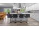 Modern kitchen with white cabinets, stainless steel appliances, an island with seating, and a tile backsplash at 806 N Central Ave, Locust, NC 28097