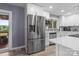 Modern kitchen featuring stainless steel appliances, white cabinets, and a tile backsplash at 806 N Central Ave, Locust, NC 28097